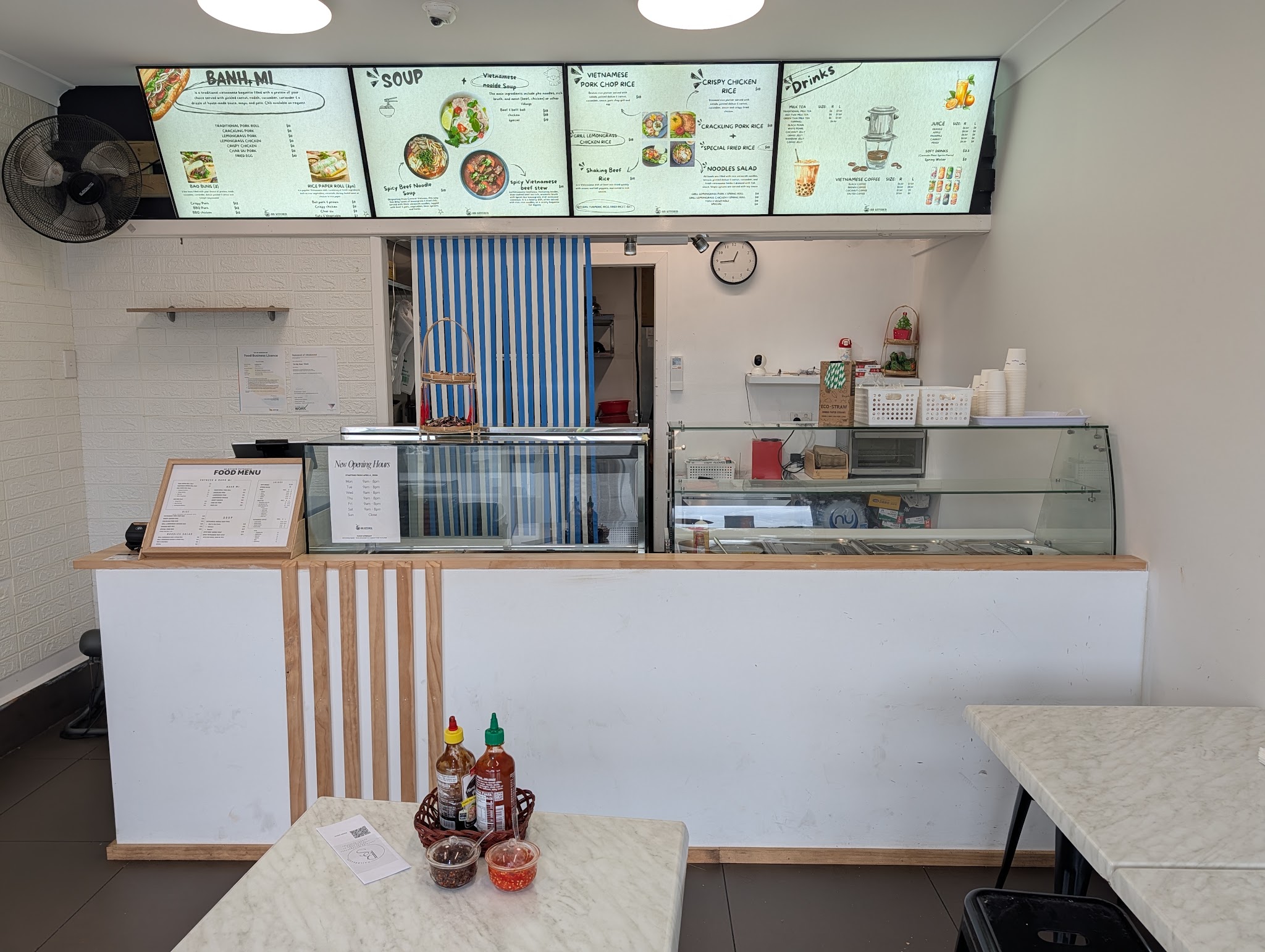 The counter at An Kitchen with the menu board above it